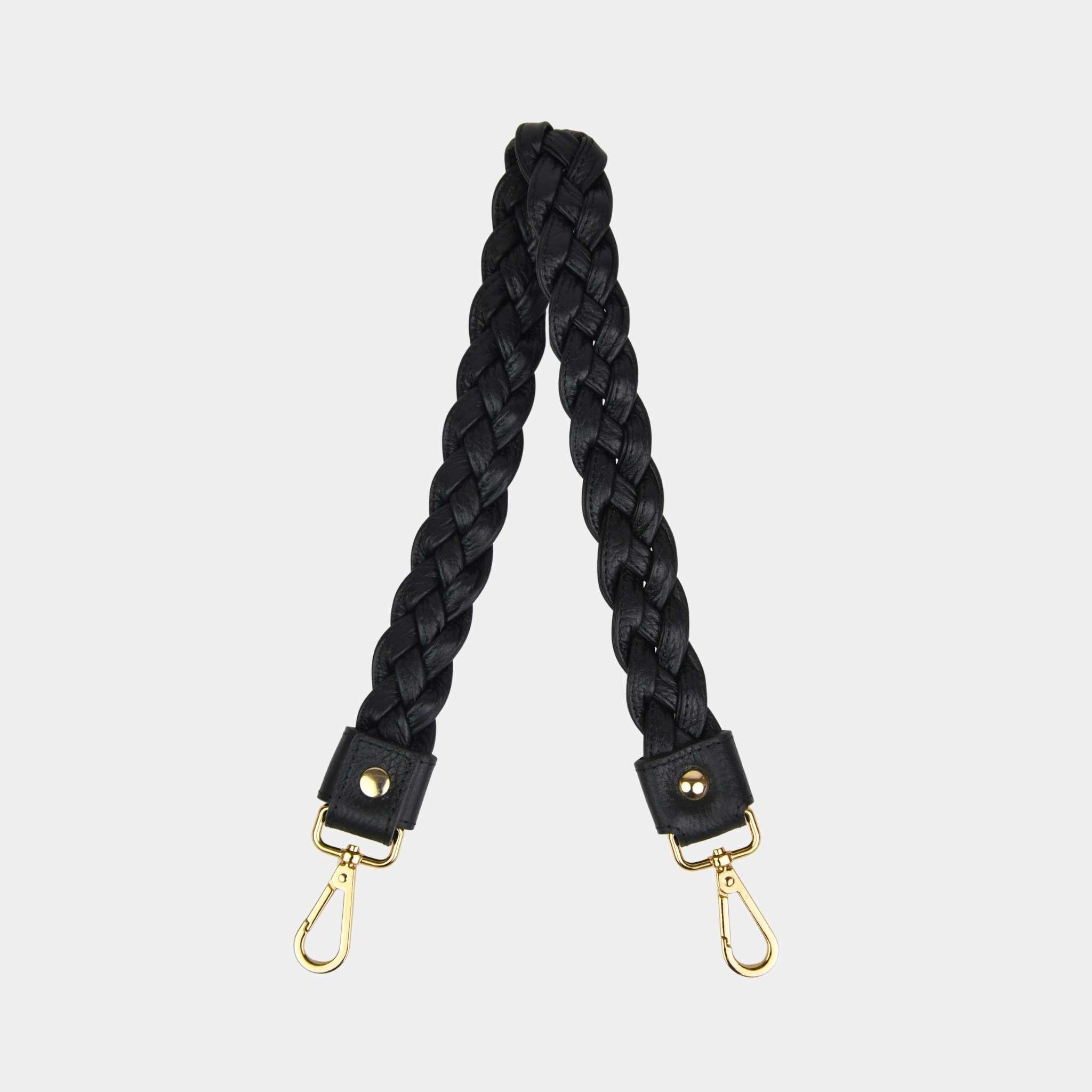 Flettet skulderstropp i Klassisk Ku-skinn, gulldetaljer. Hippi Grace Flettet Rund Skulderstropp i klassisk sort med gulldetaljer. Ekte skinn. Norsk Design. Skinnstropp til veske. Skulderstropp til veske. Skinnveske tilbehør. Skulderstropp i ekte skinn med flette detaljer.