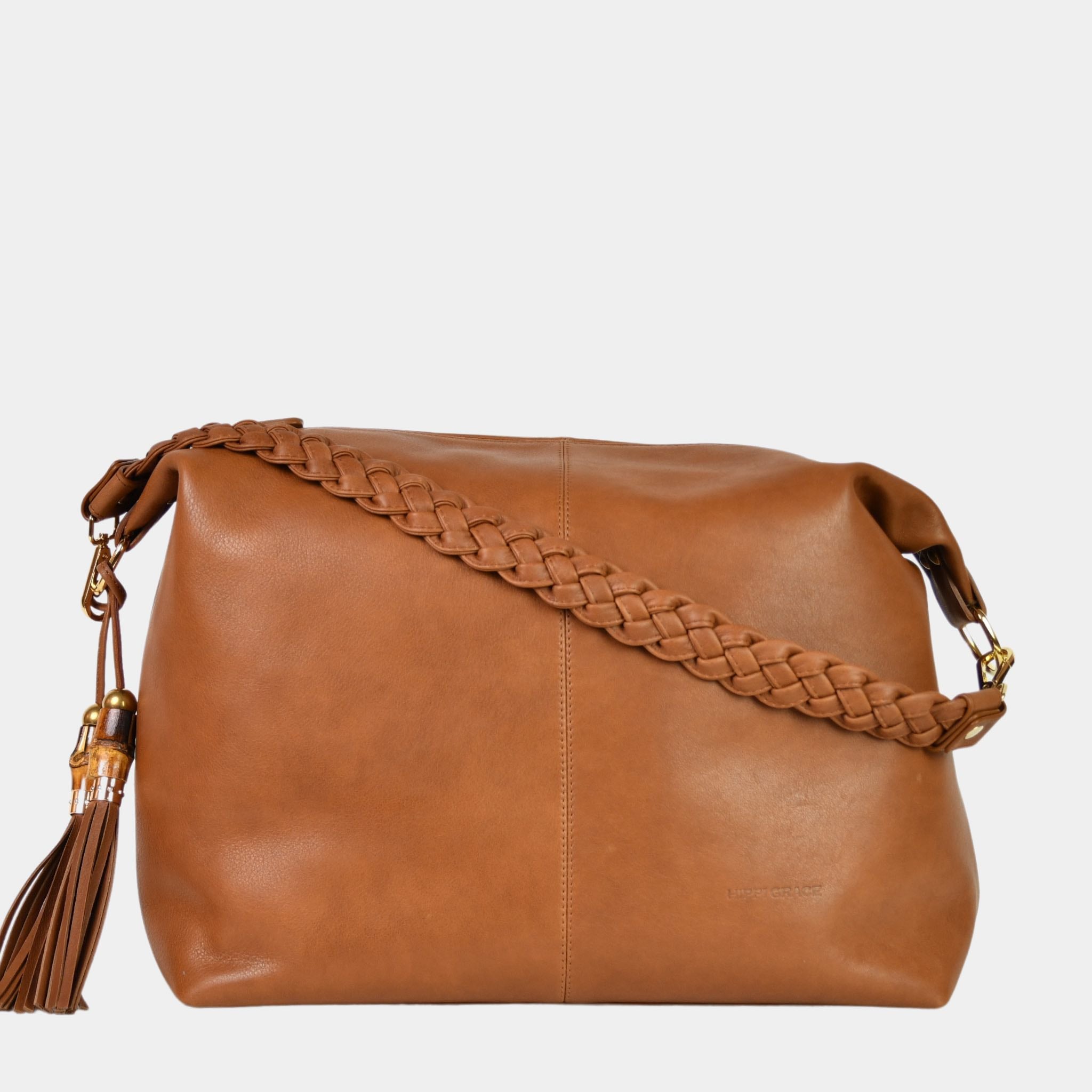 Romslig hverdags-veske i Ku skinn, flettet skulderreim, glidelås-lukning og skinn-frynse detaljer. Veske dame. Skinn Veske til dame. bag. Pc veske dame. Jobbveske dame. Hverdagsveske dame. Skoleveske dame. Reiseveske dame. Stor skinn veske til dame. Barcelona Hippi Grace. Brun veske. Brun skinnveske dame. Lys brun skinnveske dame. Lysebrun veske i ekte skinn. Crossbodyveske dame. Skulderveske dame. Hippi Grace Barcelona i fargen Bohem luxe tan Smooth med gull detaljer